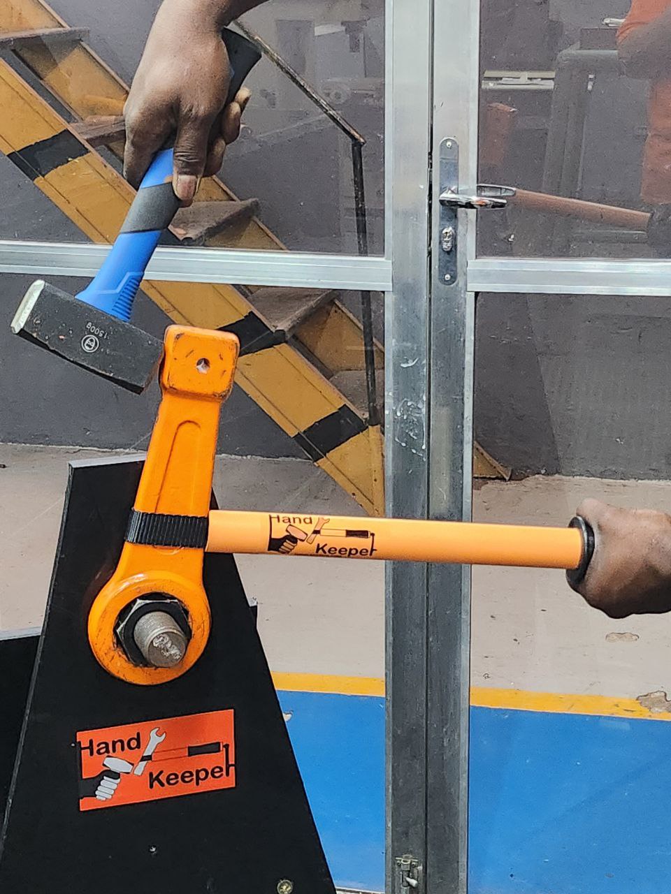 Bench demonstration: an operator holds the extender supporting a striking wrench